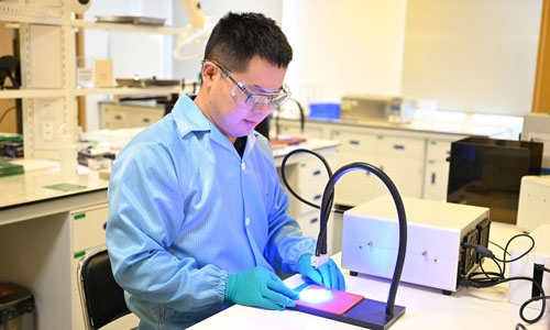 A lab technician performs a light-curing study in the application engineering lab.