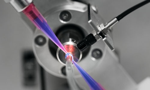 Adhesive is dispensed onto a tube set using the Dymax RotoSpense 360 dispensing workstation.